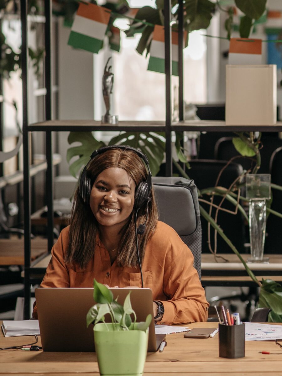Smiling patient care team member wearing a headset at her desk