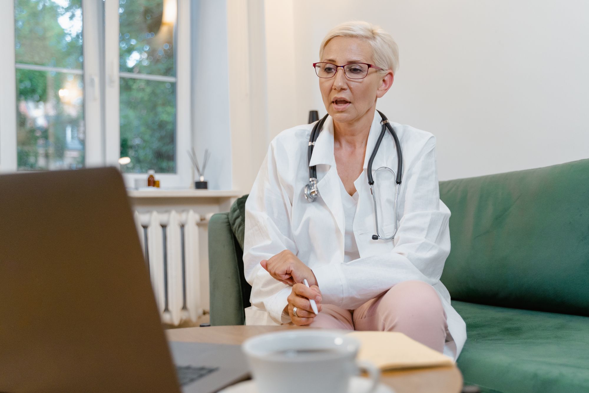Experienced provider in a white coat during a video consultation